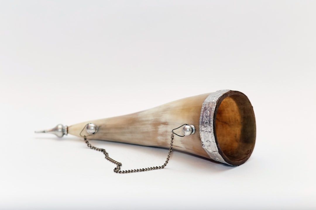 Vintage acoustic recording horn with a chain and decorated metal rim