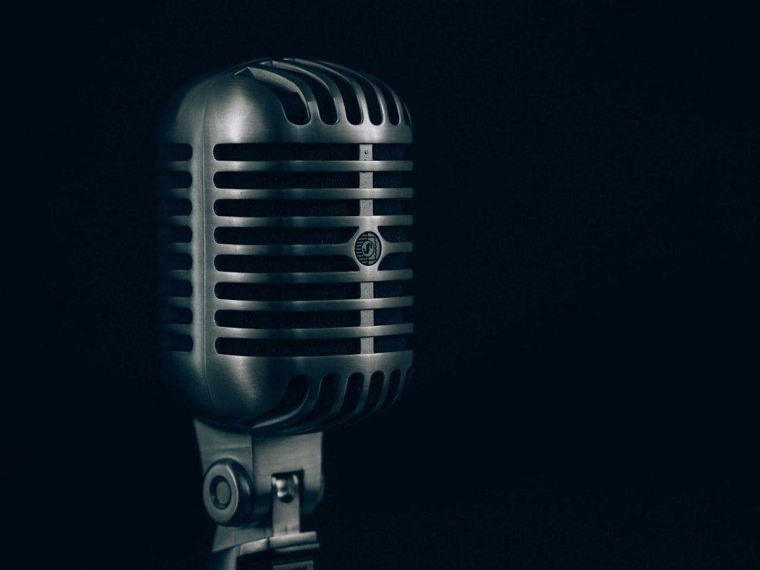 Vintage silver microphone with horizontal grille in dramatic low light