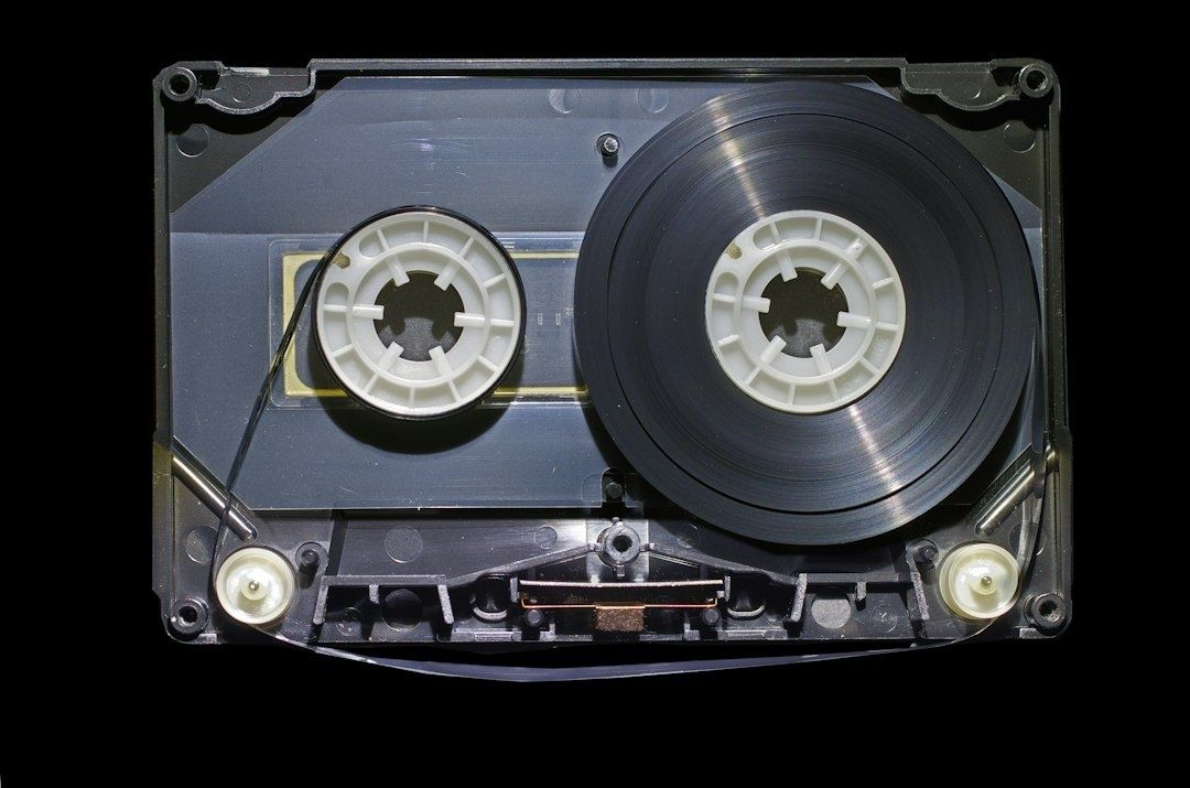 Open compact cassette showing its magnetic tape reels and internal mechanism