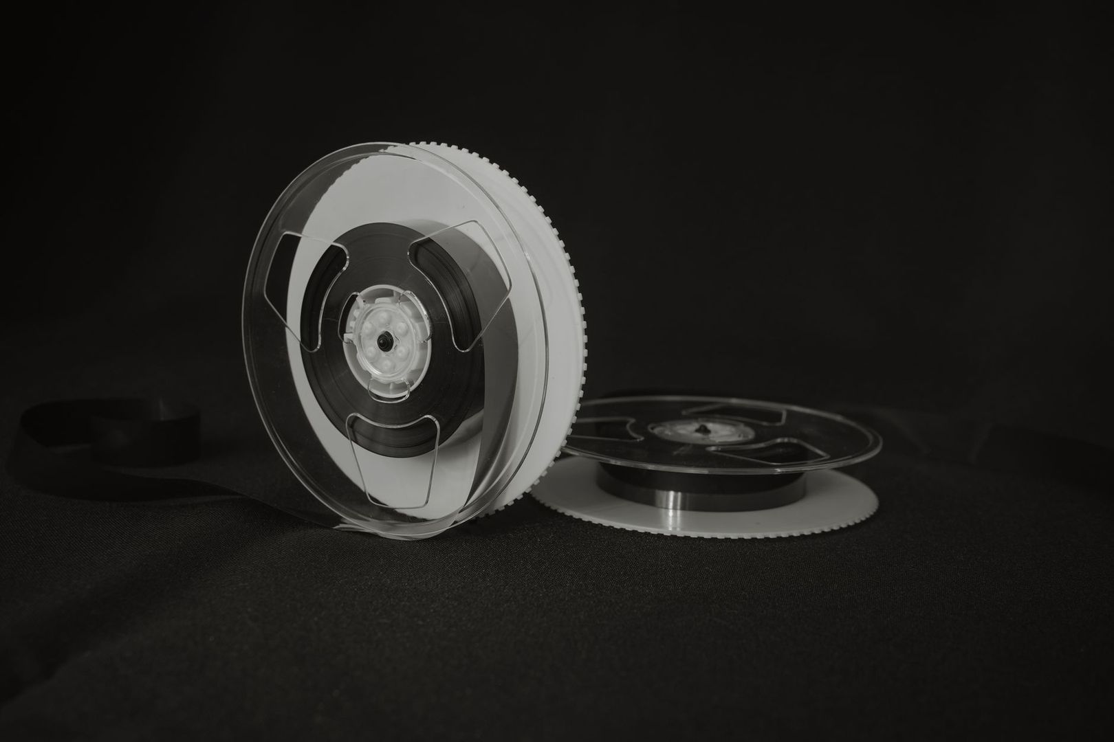 Open magnetic tape reels displayed against a dark background