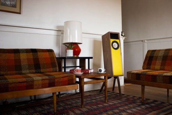 Mid-century living room with vintage stereo speaker between two sofas